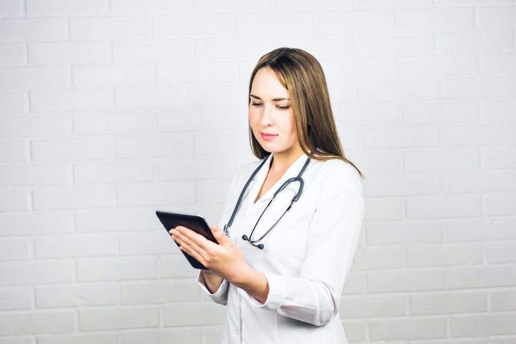 Portrait of a nurse using a digital tablet. Copy-space